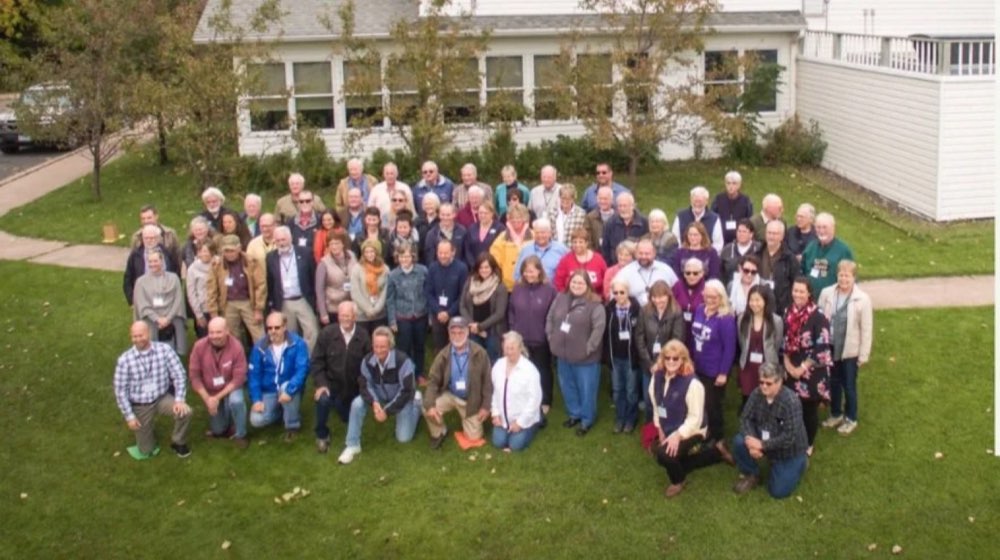 A big group photo on the lawn outside Bell Street