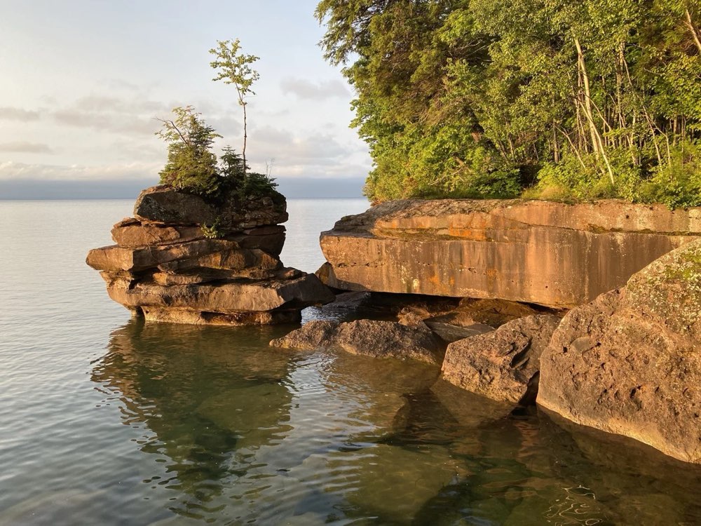 Red sandstone rocks and trees on the Lake Superior shore