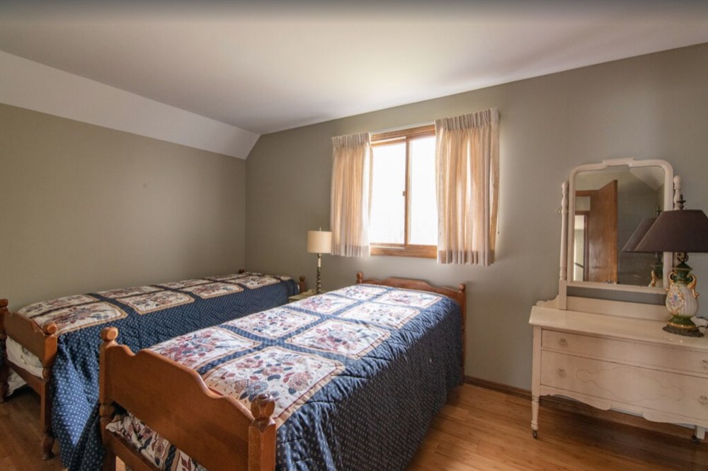 Bedroom with two twin beds and blue quilts
