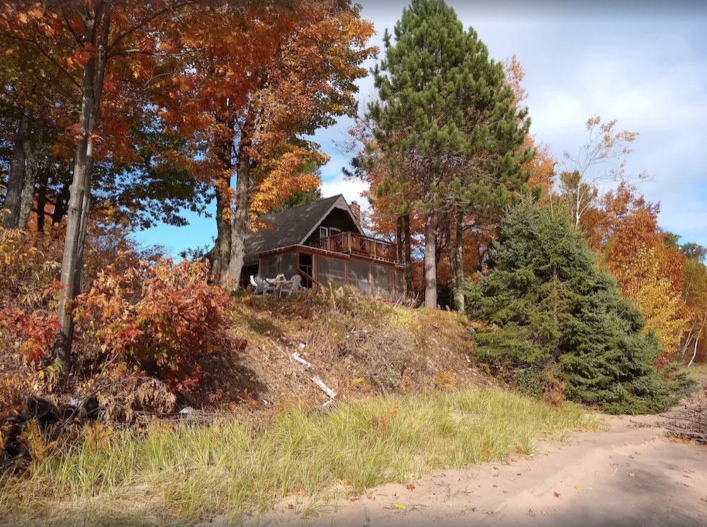 The cabin through the fall trees
