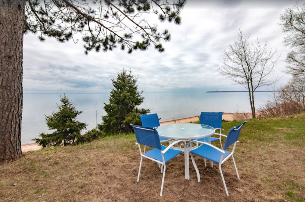 Patio chairs on the lawn above the lake