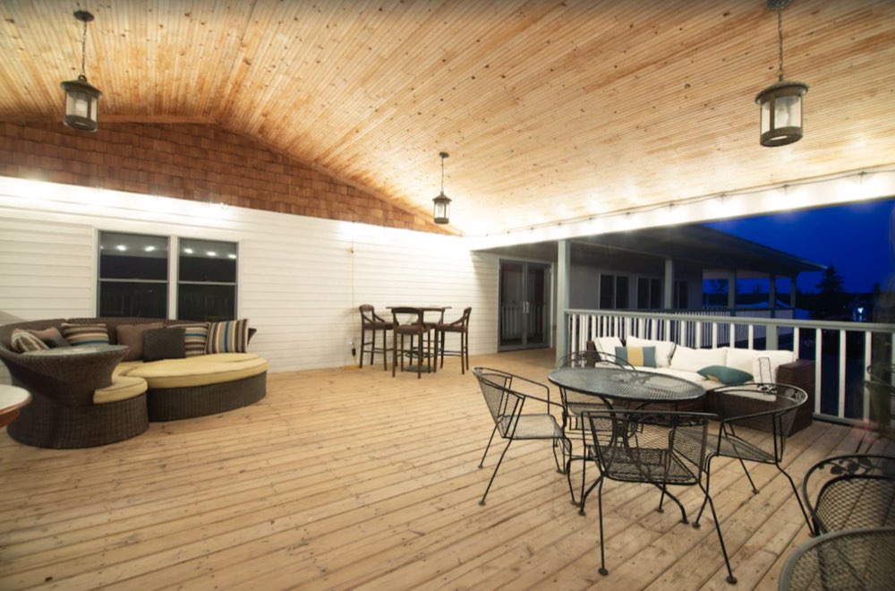 The covered deck upstairs, lit with string lights at night