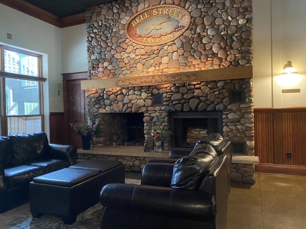 Leather couches around the big stone fireplace
