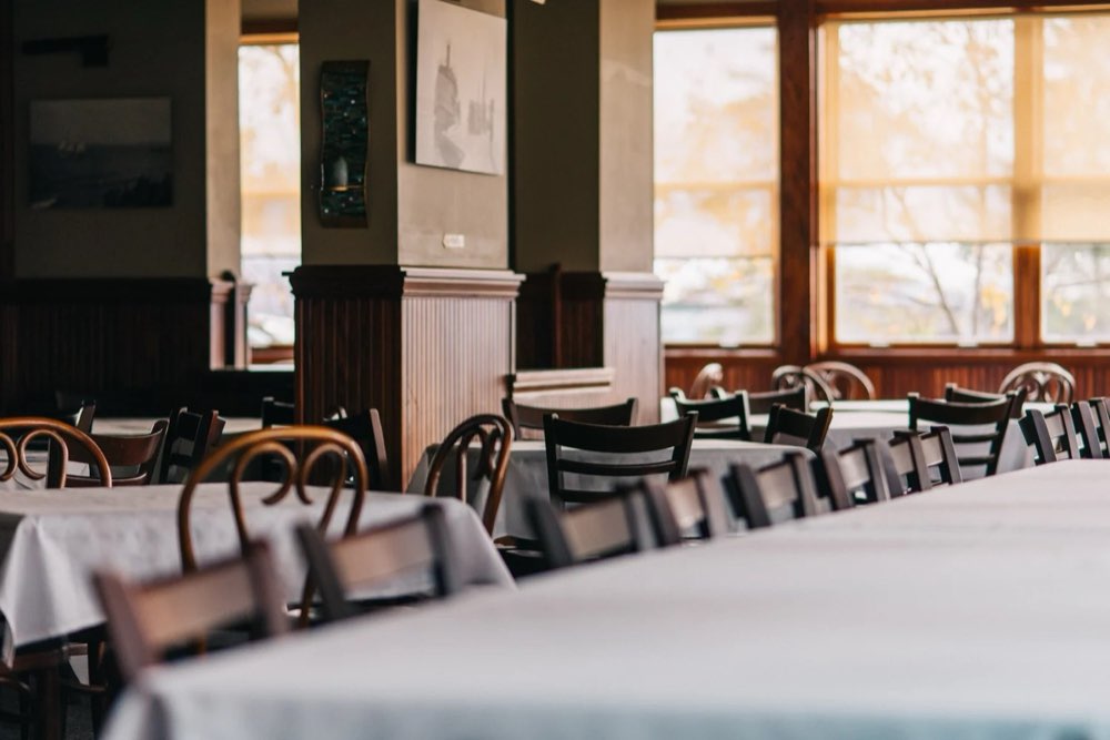 The dining room with white tablecloths and big windows